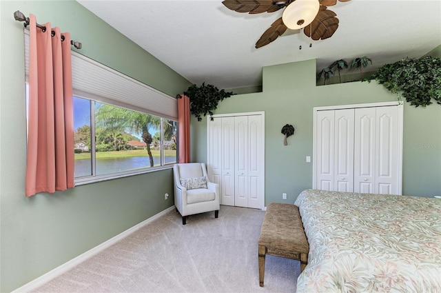 8315 Eagle Xing, Sarasota, FL 34241 - bedroom featuring two closets, carpet flooring, a ceiling fan, and a water view
