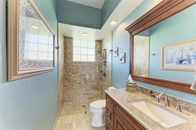 8315 Eagle Xing, Sarasota, FL 34241 - bathroom featuring vanity, a tile shower, and a textured wall