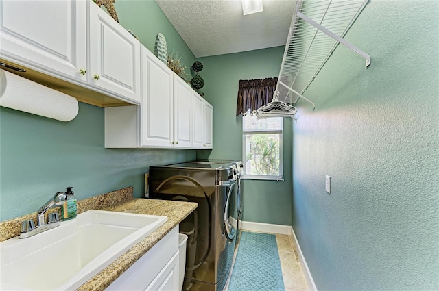 8315 Eagle Xing, Sarasota, FL 34241 - laundry area featuring washing machine and dryer, cabinet space, and a textured ceiling