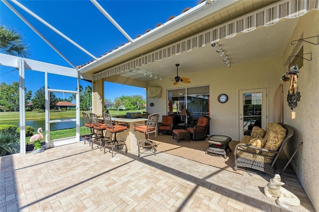 8315 Eagle Xing, Sarasota, FL 34241 - view of patio featuring a ceiling fan, a water view, and a lanai
