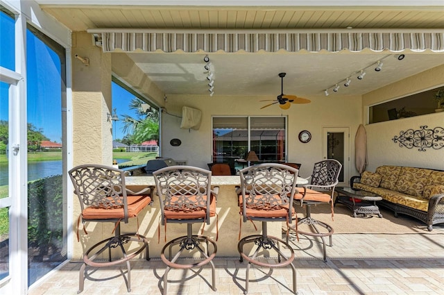 8315 Eagle Xing, Sarasota, FL 34241 - view of patio / terrace with outdoor dining space, ceiling fan, outdoor lounge area, and a water view