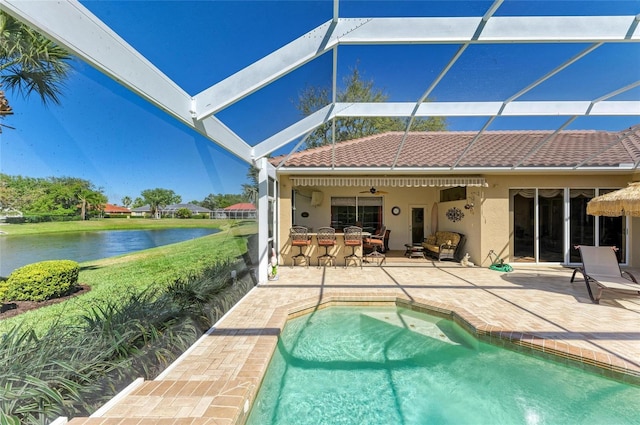 8315 Eagle Xing, Sarasota, FL 34241 - rear view of property with stucco siding, a patio, a water view, and an outdoor pool