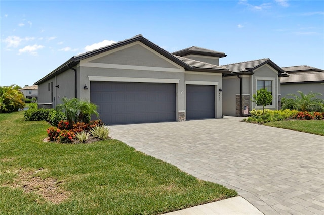 4961 Seafoam Trl, Bradenton, FL 34211 - ranch-style home with a garage, a front lawn, stucco siding, and decorative driveway