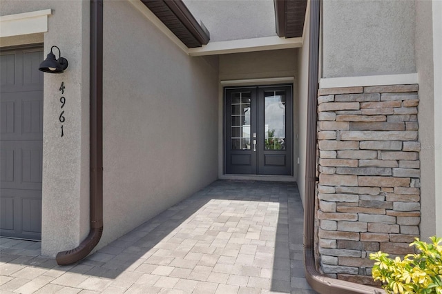 4961 Seafoam Trl, Bradenton, FL 34211 - property entrance featuring stucco siding, french doors, and stone siding
