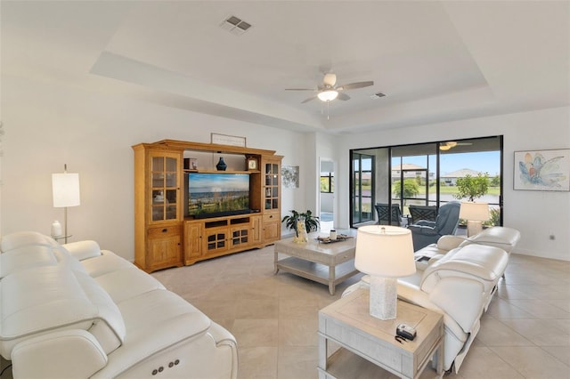 4961 Seafoam Trl, Bradenton, FL 34211 - living area featuring a raised ceiling, ceiling fan, and light tile patterned floors