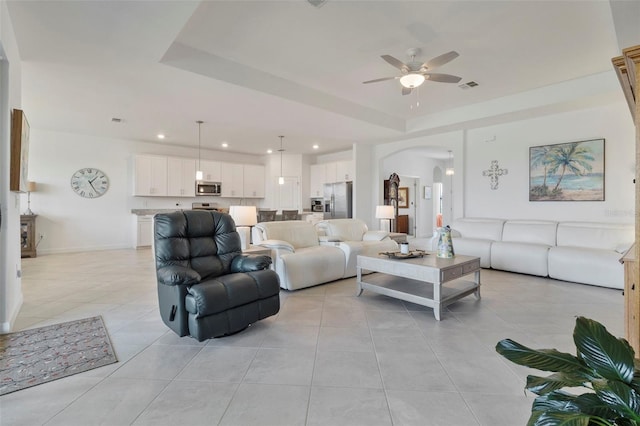 4961 Seafoam Trl, Bradenton, FL 34211 - living room with arched walkways, a ceiling fan, light tile patterned floors, recessed lighting, and a raised ceiling