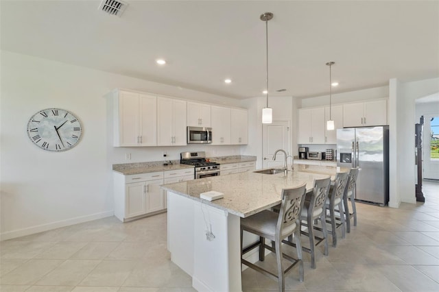 4961 Seafoam Trl, Bradenton, FL 34211 - kitchen featuring stainless steel appliances, white cabinetry, a breakfast bar, and recessed lighting