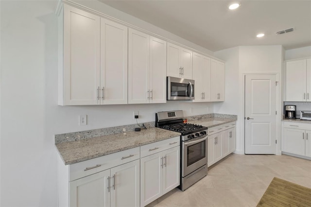 4961 Seafoam Trl, Bradenton, FL 34211 - kitchen featuring stainless steel appliances, white cabinets, recessed lighting, and light stone countertops