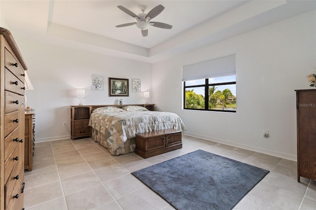 4961 Seafoam Trl, Bradenton, FL 34211 - bedroom with light tile patterned floors, a raised ceiling, and a ceiling fan
