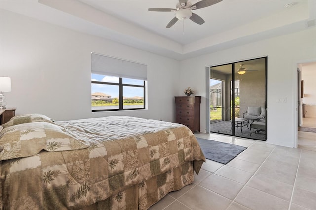 4961 Seafoam Trl, Bradenton, FL 34211 - bedroom with access to outside, light tile patterned floors, a raised ceiling, and a ceiling fan