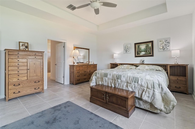 4961 Seafoam Trl, Bradenton, FL 34211 - bedroom featuring light tile patterned floors, ceiling fan, and a tray ceiling