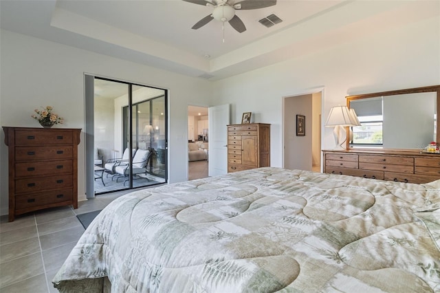 4961 Seafoam Trl, Bradenton, FL 34211 - bedroom featuring light tile patterned floors, a raised ceiling, and ceiling fan