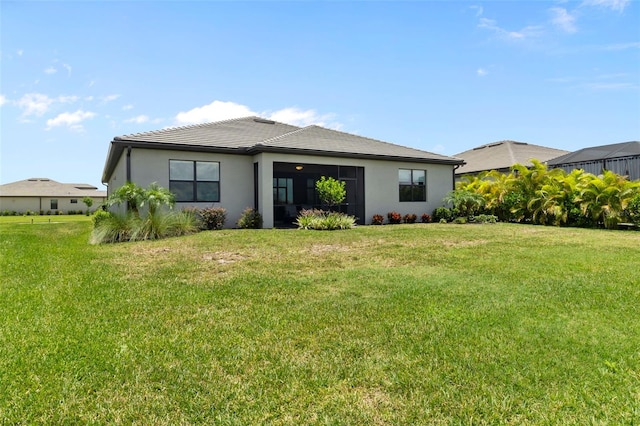 4961 Seafoam Trl, Bradenton, FL 34211 - back of house with stucco siding, a lawn, and a tiled roof