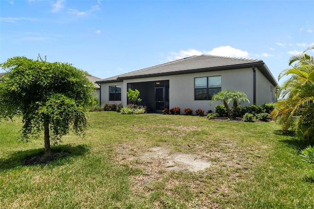 4961 Seafoam Trl, Bradenton, FL 34211 - rear view of property with a lawn, stucco siding, and a tiled roof