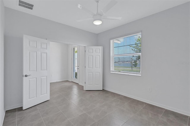7352 Cabin Ln, Sarasota, FL 34240 - empty room featuring ceiling fan and light tile patterned floors