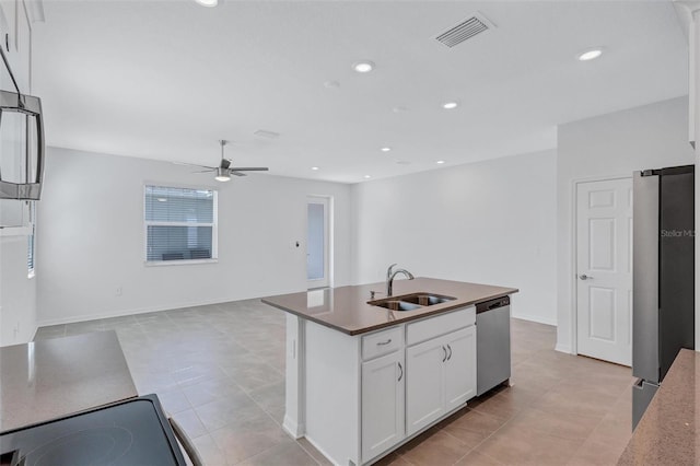 7352 Cabin Ln, Sarasota, FL 34240 - kitchen with appliances with stainless steel finishes, ceiling fan, white cabinetry, open floor plan, and light tile patterned flooring