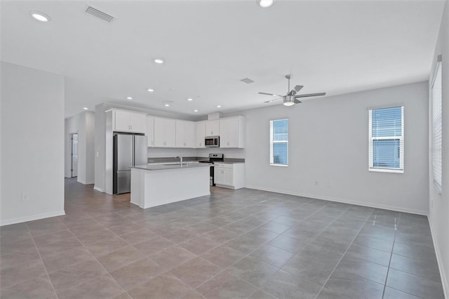 7352 Cabin Ln, Sarasota, FL 34240 - kitchen featuring appliances with stainless steel finishes, open floor plan, a ceiling fan, light tile patterned floors, and recessed lighting