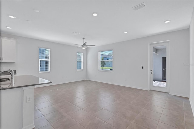 7352 Cabin Ln, Sarasota, FL 34240 - unfurnished living room featuring ceiling fan, light tile patterned floors, and recessed lighting