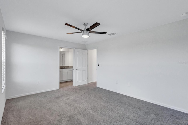 7352 Cabin Ln, Sarasota, FL 34240 - unfurnished bedroom featuring light carpet, connected bathroom, and a ceiling fan