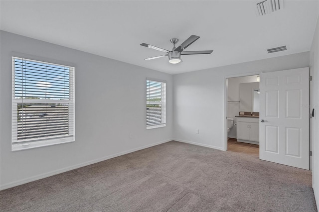 7352 Cabin Ln, Sarasota, FL 34240 - unfurnished bedroom with light carpet, ensuite bathroom, and ceiling fan