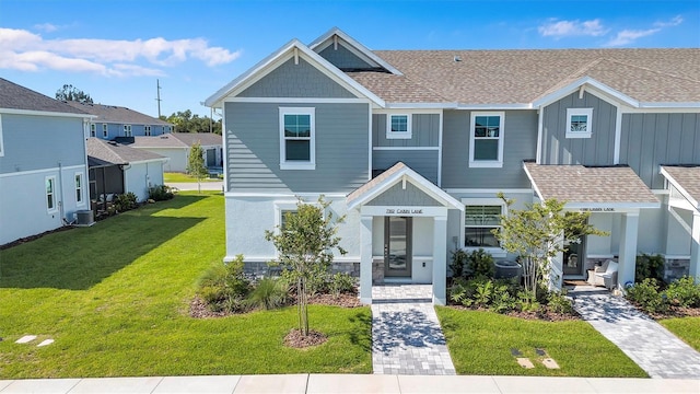 7352 Cabin Ln, Sarasota, FL 34240 - view of front of property featuring a shingled roof and a front yard