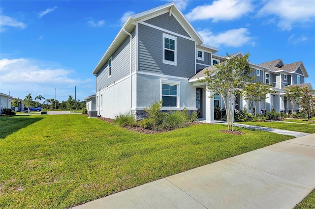 7352 Cabin Ln, Sarasota, FL 34240 - view of front of house featuring a front lawn, stucco siding, and a residential view