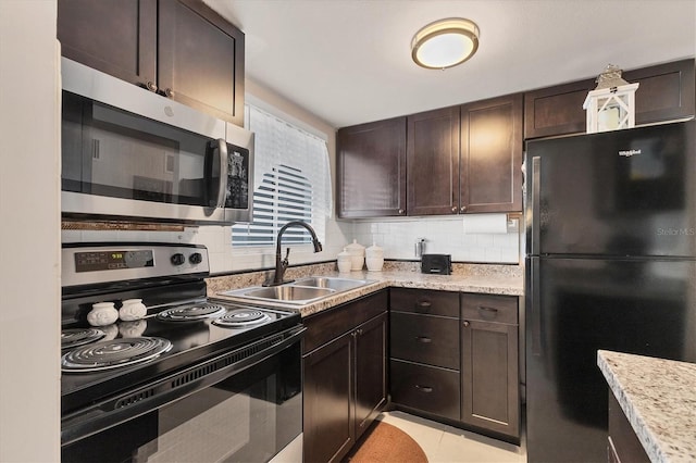 5891 Welcome Rd Unit I6, Bradenton, FL 34207 - kitchen featuring black appliances, dark brown cabinets, and tasteful backsplash