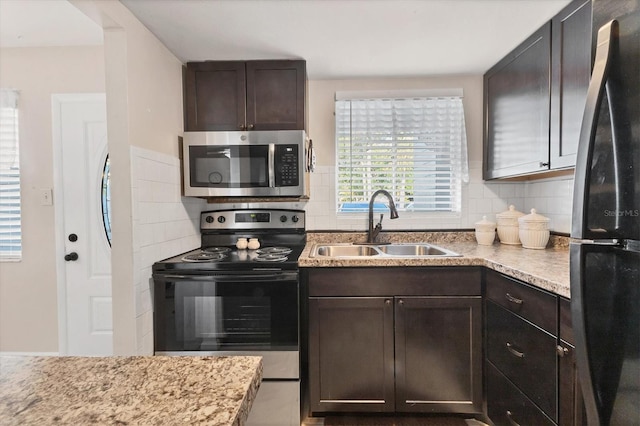 5891 Welcome Rd Unit I6, Bradenton, FL 34207 - kitchen with stainless steel appliances, dark brown cabinetry, decorative backsplash, and light stone countertops