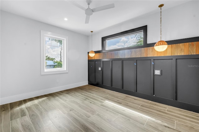 646 Calle Del Otono, Sarasota, FL 34242 - empty room with plenty of natural light, ceiling fan, wood finished floors, and recessed lighting