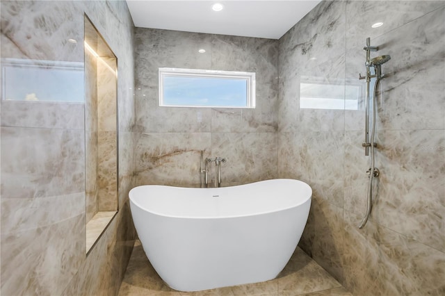 646 Calle Del Otono, Sarasota, FL 34242 - full bath with a soaking tub, a tile shower, and tile walls