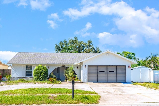 3805 Sandpointe Dr, Bradenton, FL 34205 - ranch-style home with a gate, stucco siding, an attached garage, and driveway