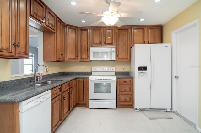 3805 Sandpointe Dr, Bradenton, FL 34205 - kitchen with white appliances, brown cabinets, ceiling fan, recessed lighting, and dark stone counters