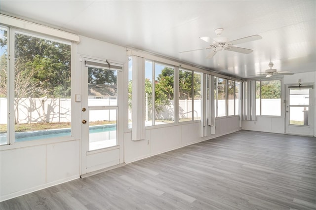3805 Sandpointe Dr, Bradenton, FL 34205 - unfurnished sunroom featuring wood finished floors, healthy amount of natural light, and a deck