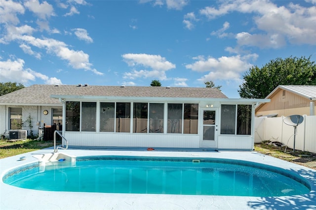 3805 Sandpointe Dr, Bradenton, FL 34205 - back of property with a sunroom, an outdoor pool, and a shingled roof