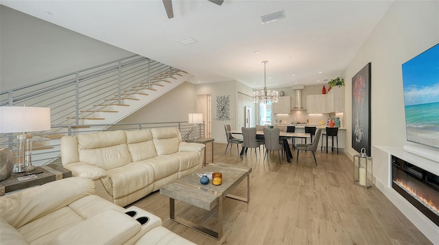 626 Rawls Ave Unit 626, Sarasota, FL 34236 - living area with light wood-type flooring, a chandelier, a ceiling fan, a glass covered fireplace, and recessed lighting
