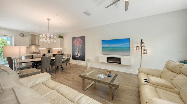 626 Rawls Ave Unit 626, Sarasota, FL 34236 - living room featuring a chandelier, a glass covered fireplace, light wood-style flooring, recessed lighting, and a ceiling fan