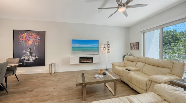 626 Rawls Ave Unit 626, Sarasota, FL 34236 - living area featuring wood finished floors, a ceiling fan, and a glass covered fireplace