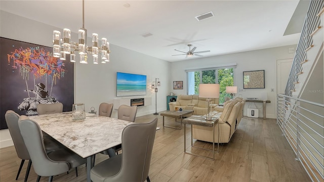 626 Rawls Ave Unit 626, Sarasota, FL 34236 - dining space with light wood-style flooring, ceiling fan, and stairway