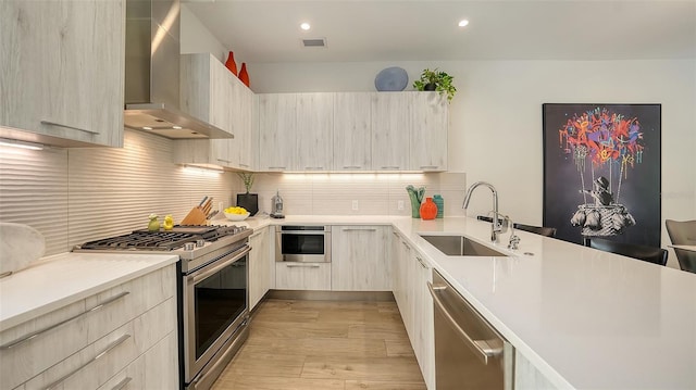 626 Rawls Ave Unit 626, Sarasota, FL 34236 - kitchen with wall chimney range hood, appliances with stainless steel finishes, modern cabinets, light wood-style flooring, and light countertops