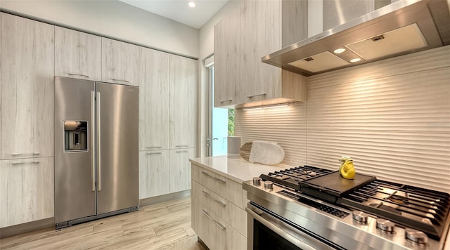 626 Rawls Ave Unit 626, Sarasota, FL 34236 - kitchen featuring stainless steel appliances, extractor fan, modern cabinets, light wood-type flooring, and recessed lighting