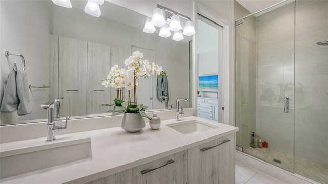 626 Rawls Ave Unit 626, Sarasota, FL 34236 - full bath with double vanity, a stall shower, a chandelier, and tile patterned floors