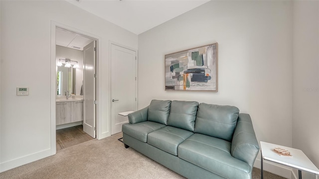 626 Rawls Ave Unit 626, Sarasota, FL 34236 - carpeted living area featuring baseboards and a sink