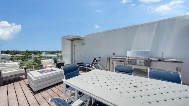 626 Rawls Ave Unit 626, Sarasota, FL 34236 - wooden deck featuring a fire pit, a grill, and outdoor dining space