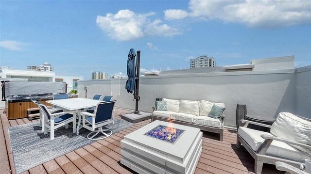 626 Rawls Ave Unit 626, Sarasota, FL 34236 - deck with an outdoor living space with a fire pit, a hot tub, and outdoor dining space