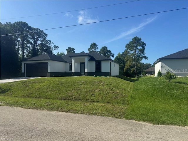 3003 18th St W, Lehigh Acres, FL 33971 - view of front of home featuring stucco siding, driveway, a garage, and a front lawn