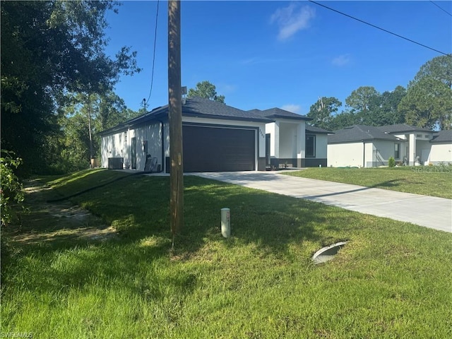 3003 18th St W, Lehigh Acres, FL 33971 - view of front of house featuring a front lawn, an attached garage, concrete driveway, and stucco siding