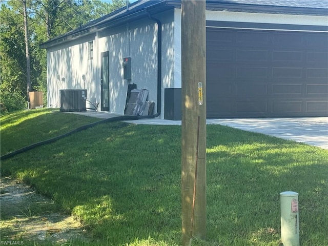 3003 18th St W, Lehigh Acres, FL 33971 - view of side of property featuring a lawn, a garage, and driveway