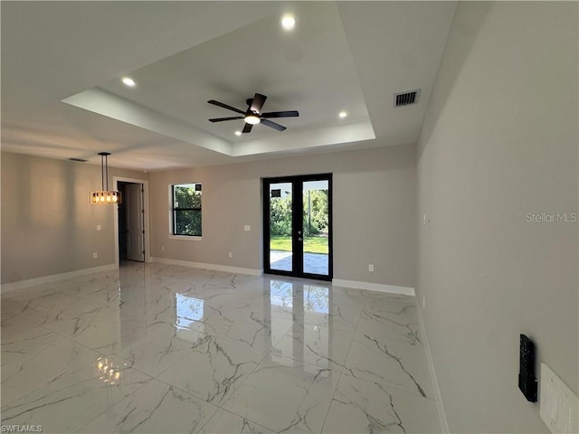 3003 18th St W, Lehigh Acres, FL 33971 - spare room with recessed lighting, light marble finish flooring, a tray ceiling, ceiling fan, and french doors