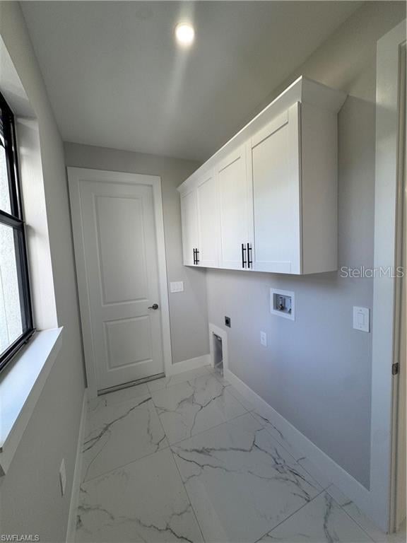 3003 18th St W, Lehigh Acres, FL 33971 - laundry area featuring hookup for an electric dryer, hookup for a washing machine, cabinet space, and light marble finish flooring