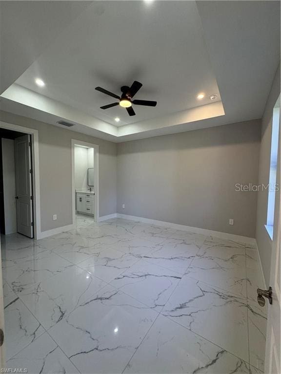 3003 18th St W, Lehigh Acres, FL 33971 - unfurnished room featuring a raised ceiling, recessed lighting, ceiling fan, and light marble finish floors